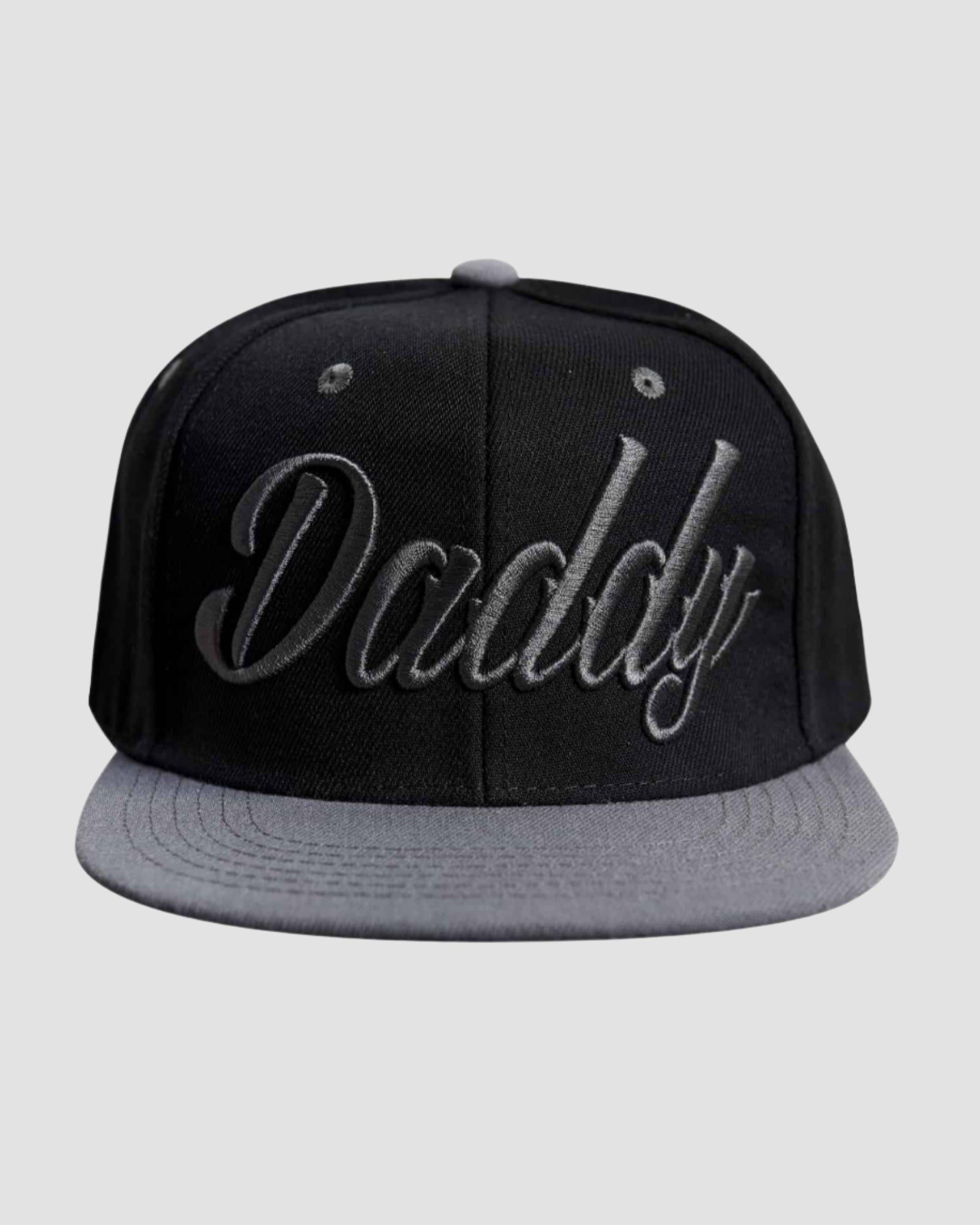 Front view of the ‘Men’s Daddy Snapback’ by Ring of Fire Clothing in Black Grey color, showcasing the stylish cursive ‘daddy’ text design, size one size.