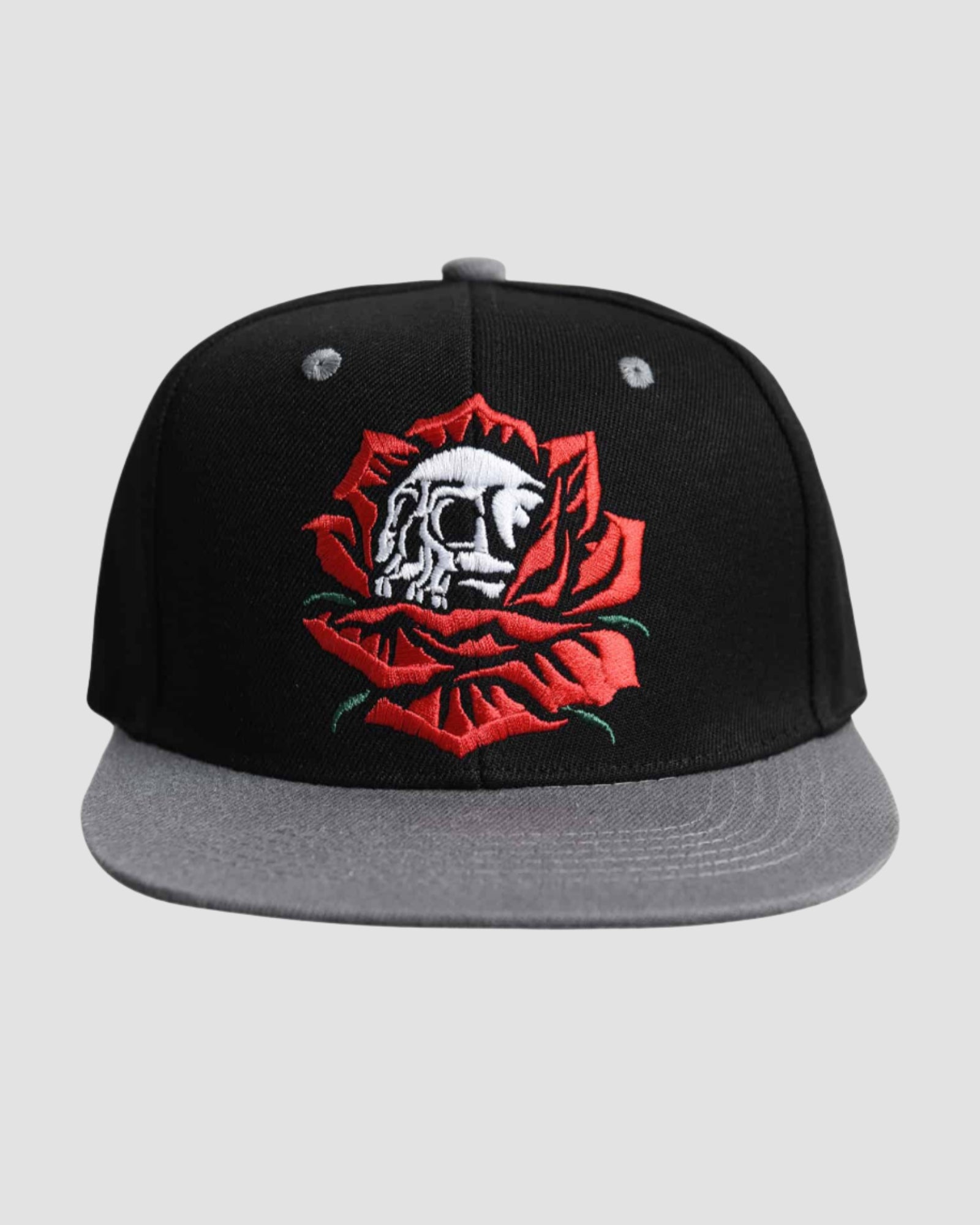 Front view of the Men’s Skull Bloom Snapback by Ring of Fire Clothing in Black, Red, White, and Grey colors, showcasing the unique rose and skull design, one size fits all.