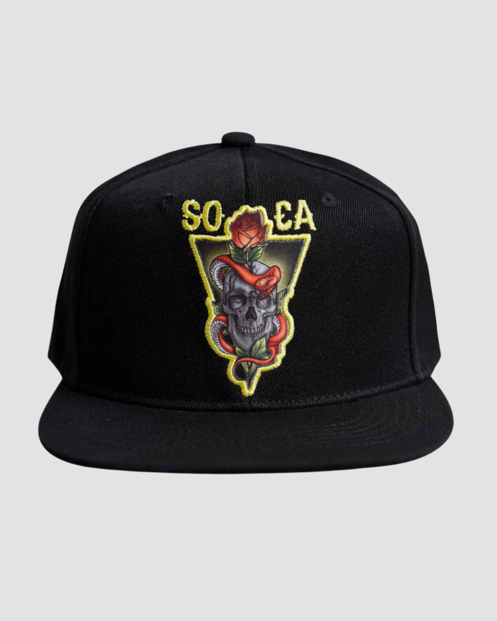 Front view of the Men’s Socal Skull Snapback by Ring of Fire Clothing in Black Gold Grey Red color, showcasing the intricate skull, snake, and rose design, and the letters ‘SO’ and ‘CA’.