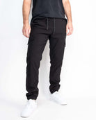 A pair of black performance tech cargo joggers with multiple pockets and a straight fit silhouette.