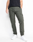 A pair of green performance tech cargo joggers with multiple pockets and a straight fit silhouette.