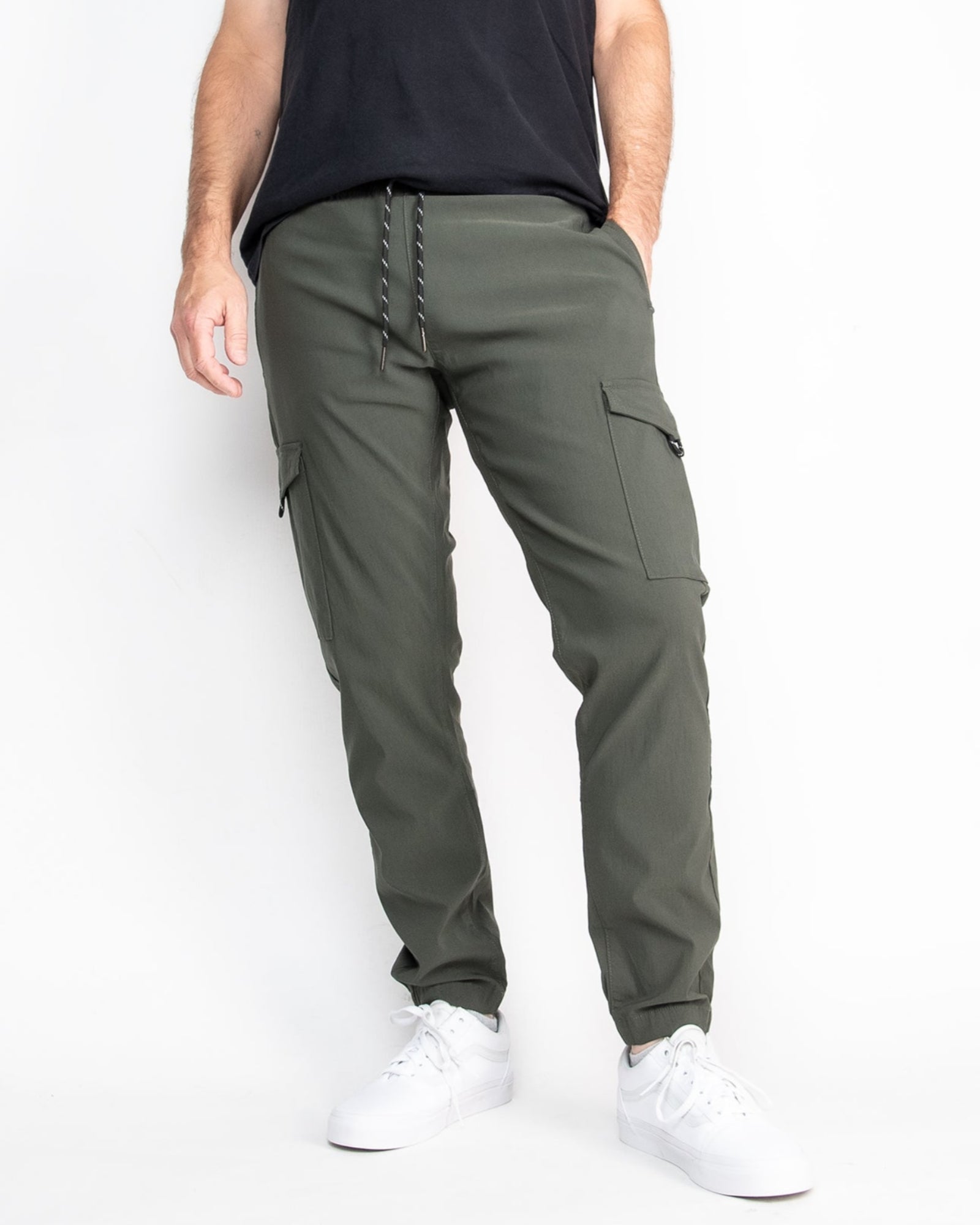 A pair of green performance tech cargo joggers with multiple pockets and a straight fit silhouette.