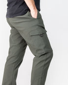 Green cargo pants worn by a person on a white background