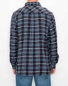 Person wearing a black and blue plaid shirt on a white background
