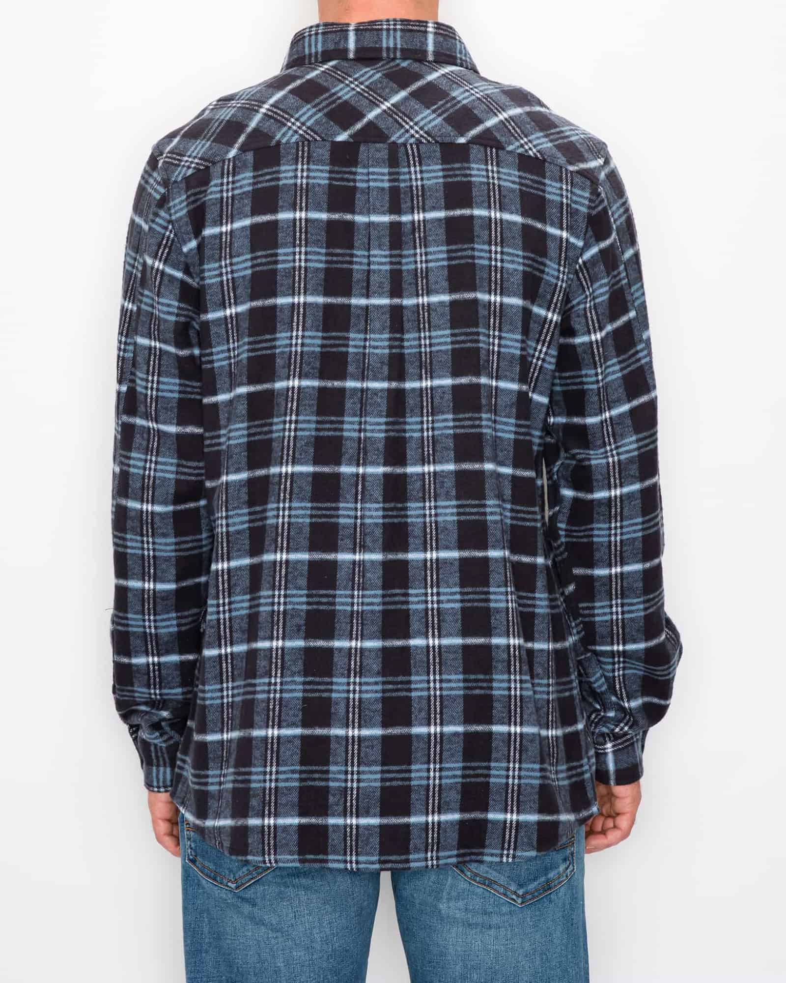 Person wearing a black and blue plaid shirt on a white background