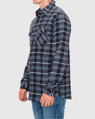 Person wearing a black and blue plaid shirt on a white background