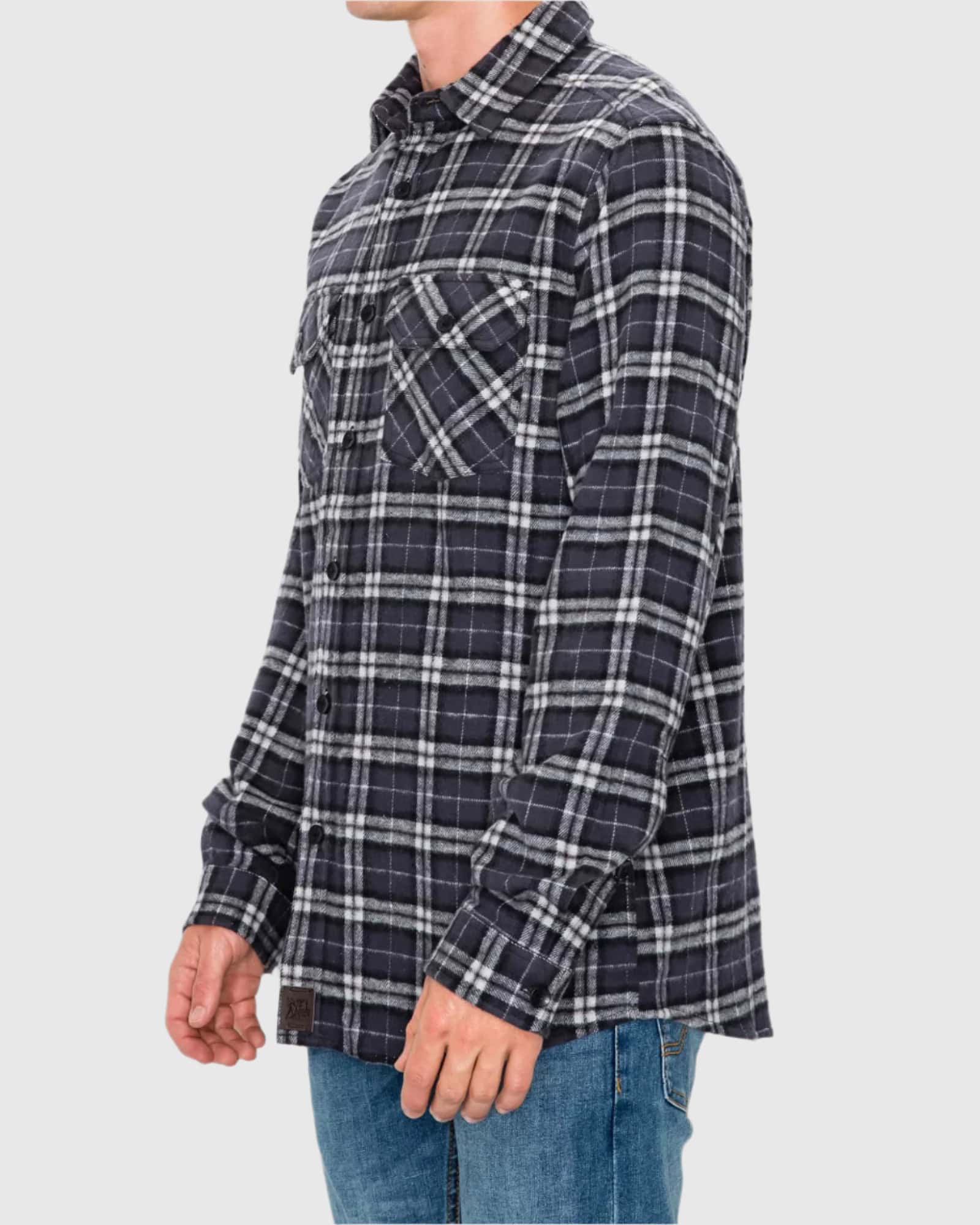 Person wearing a plaid shirt on a plain background