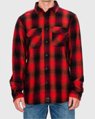 Red and black plaid shirt worn by a person on a gray background