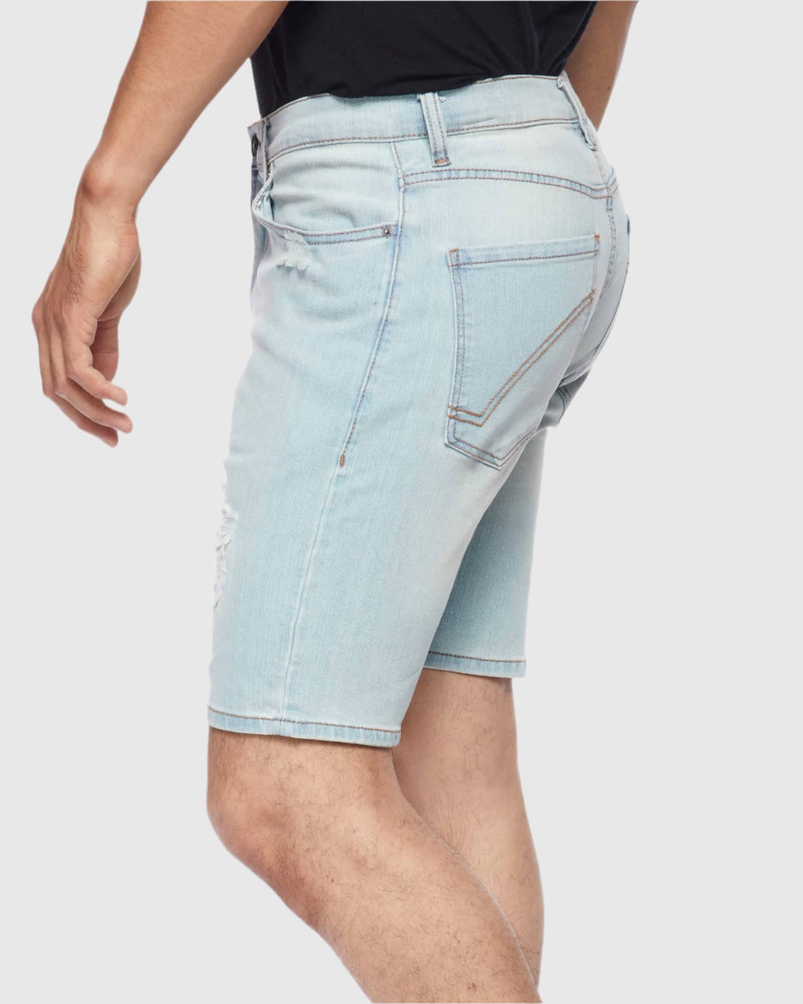 Angle shot of model in Blue Bleached Men’s Ripper Denim Shorts from Ring of Fire