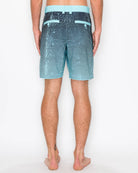 Person wearing blue and black striped shorts on a white background