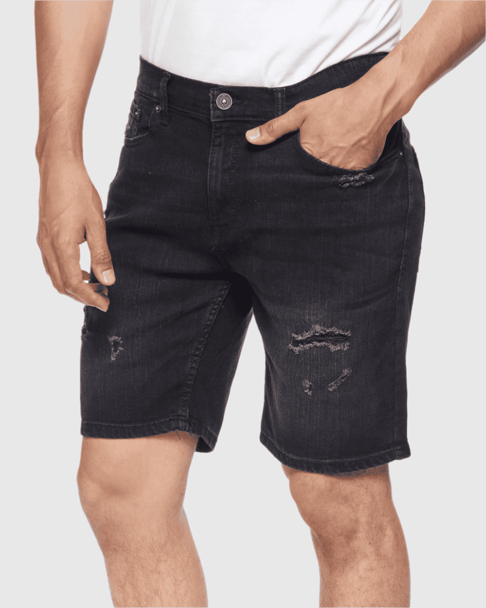 Model posing at an angle in Carbon color Men’s Ripper Denim Shorts from Ring of Fire