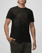 Person wearing a black t-shirt with a graphic design on a plain background