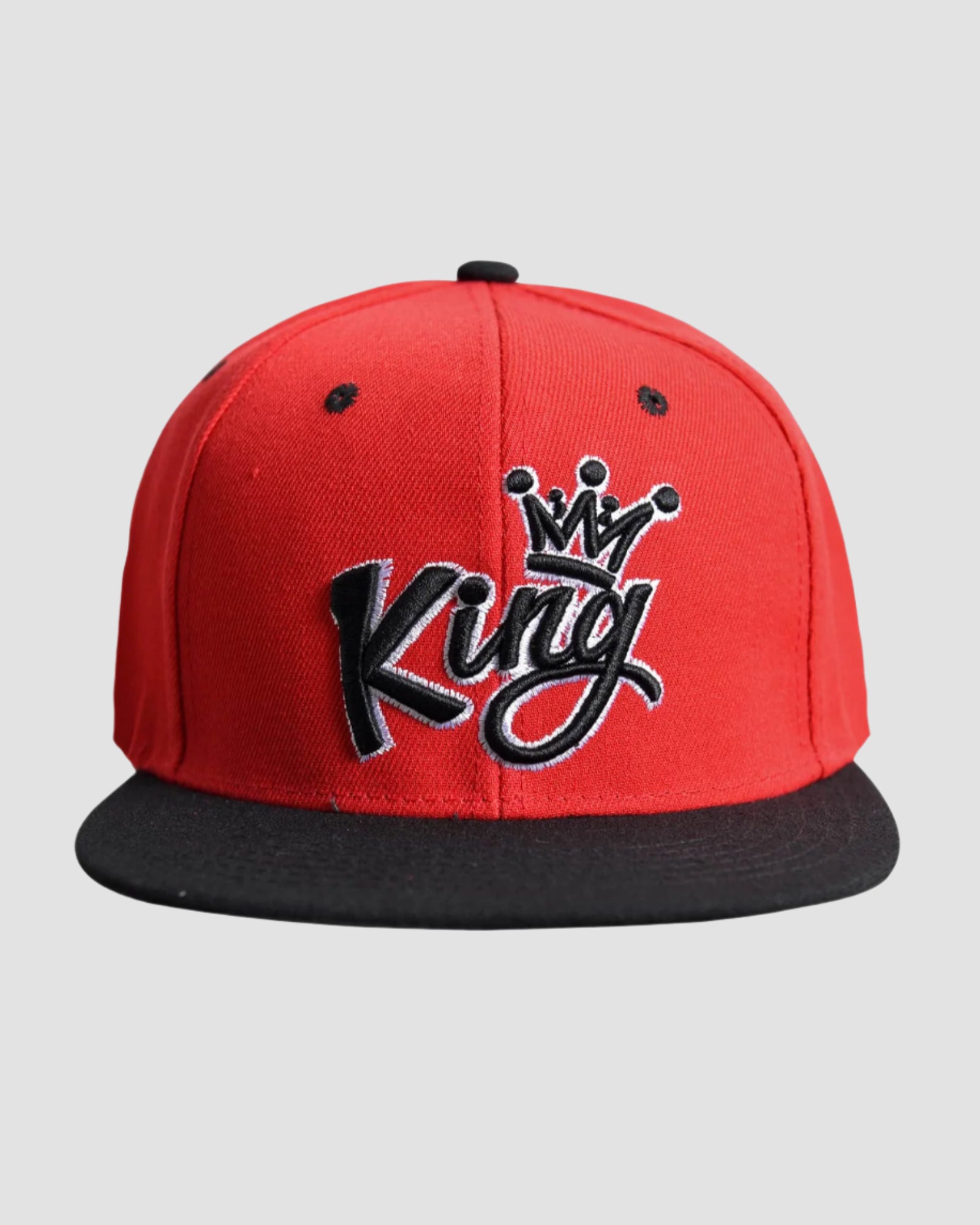 Front view of the one-size Men’s King Snapback in Red and Black colors, featuring the ‘King’ text with a crown design.