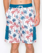 Close-up of men’s boardshorts featuring a vibrant red and blue palm tree print on a white background, with elastic waistband and drawstring closure.