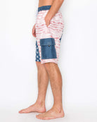 Side view of men’s Americana cargo boardshorts highlighting the velcro cargo pocket and American flag design.