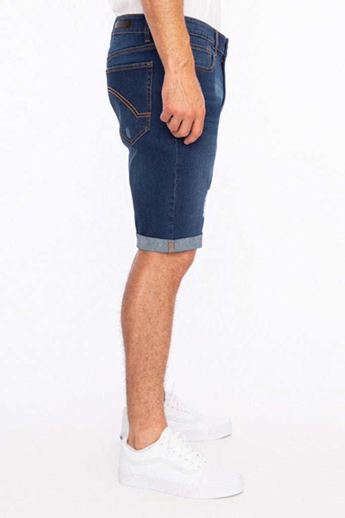 Model wearing the Men’s Jake Rip N Repair Denim Shorts in Hunter color, side angle view