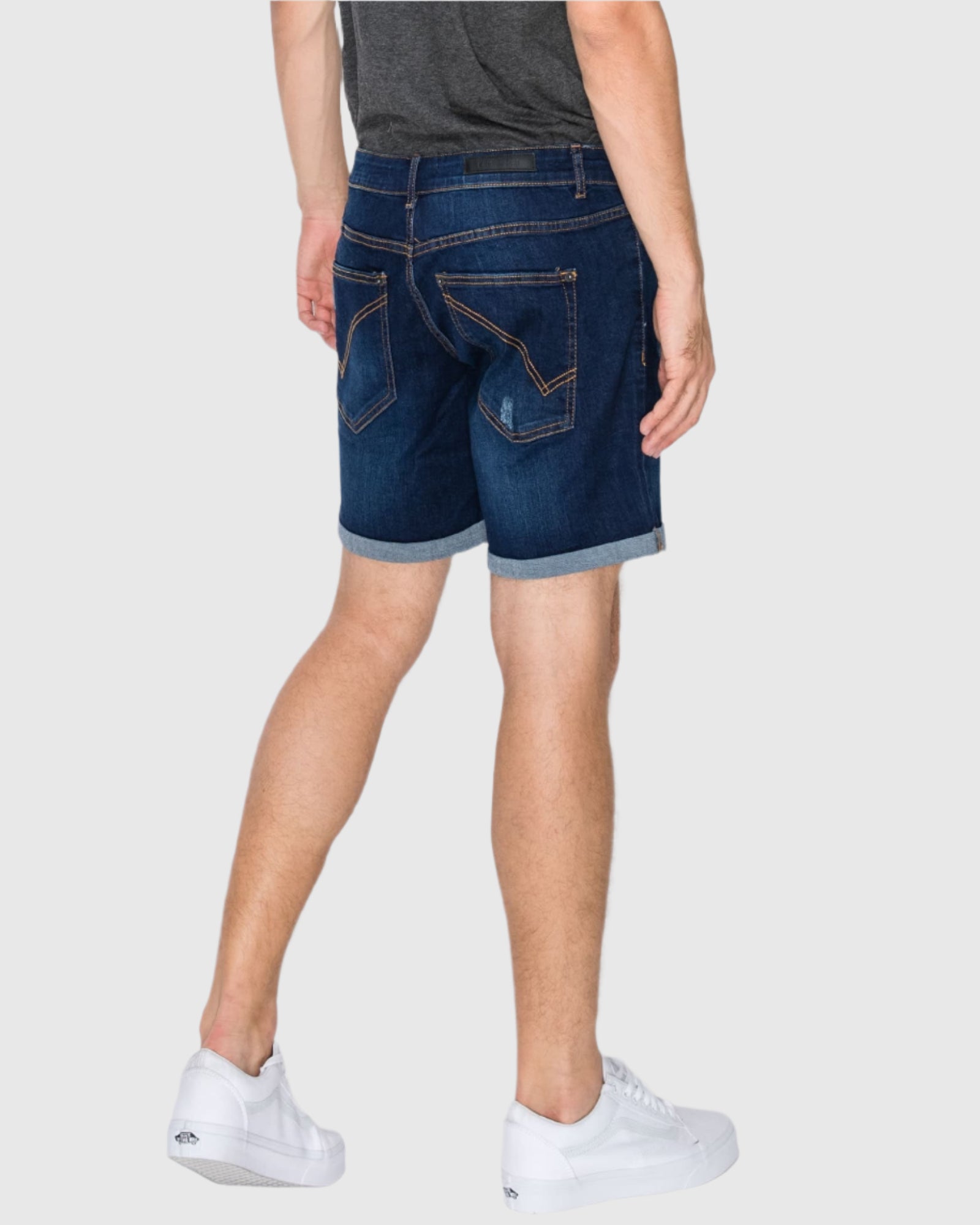 Rear angle view of the Men’s Jake Rip N Repair Denim Shorts in Twilight color, modeled