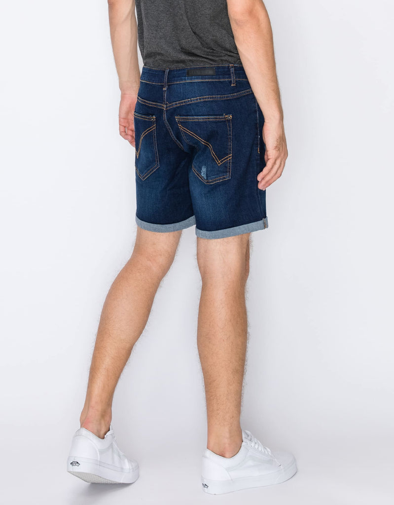 Rear angle view of the Men’s Jake Rip N Repair Denim Shorts in Twilight color, modeled