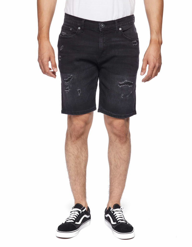 Front shot of model wearing Carbon Men’s Ripper Denim Shorts by Ring of Fire